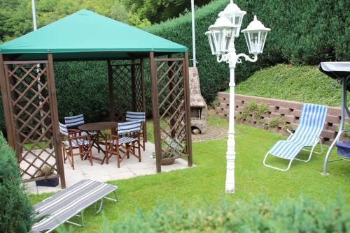 a gazebo with chairs and a table and a street light at Ferienwohnung Lisa in Medebach