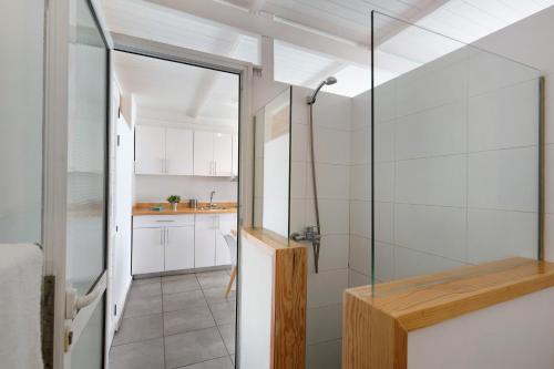 a bathroom with a shower and a glass door at Loft Amanecer in Mácher