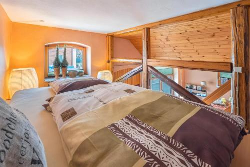 a bedroom with a large bed and a large window at Pension Schlachter's Hius in Algermissen