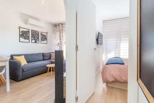 a living room with a blue couch and a table at Apartamento Tamarindos 500 in L'Estartit