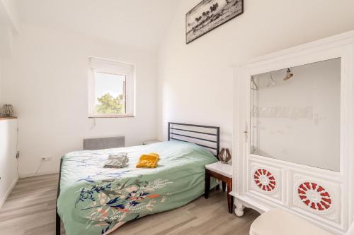 a bedroom with a bed and a mirror at Gîte Le Jardin d'Eden in Bovel