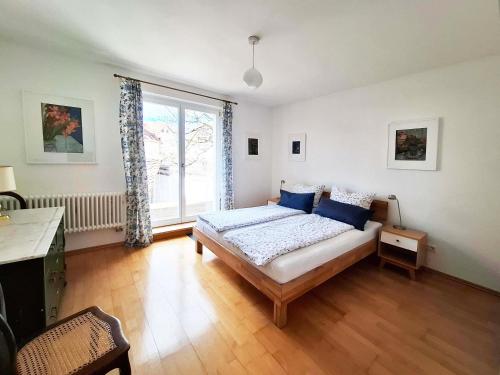 a bedroom with a bed and a large window at Schlößleweg 2a in Bodman-Ludwigshafen