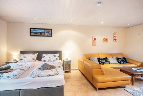 a room with two beds and a couch at Ferienwohnung Weingeist in Reil