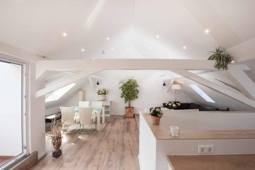 a living room with white walls and a ceiling at Haus Behr am See in Radolfzell am Bodensee