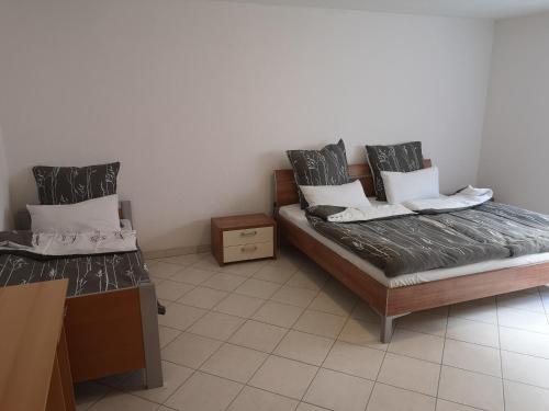 a room with two beds and a table in it at Ferienwohnung Mössingen in Mössingen