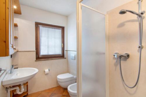 a bathroom with a toilet and a sink and a shower at Residence Larice Bianco App n6 in Campodolcino