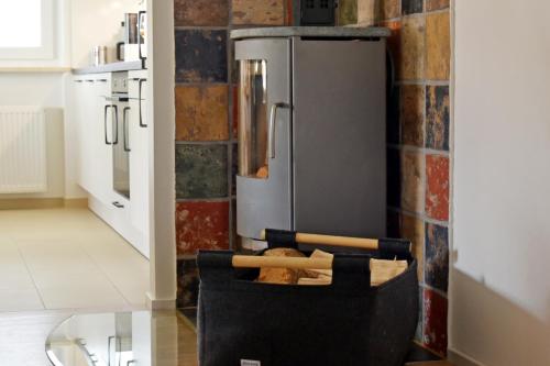 a kitchen with a refrigerator and a chair in front of it at Quartier Wellant in Weißensberg