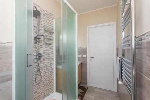 a bathroom with a shower and a glass door at Villa Veronica in Mascali