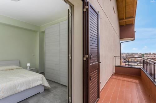 a bedroom with a bed and a balcony at Villa Veronica in Mascali