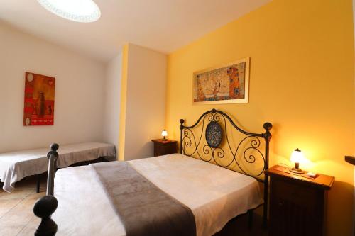 a bedroom with two beds with yellow walls at Casa Samira a Otranto in Otranto