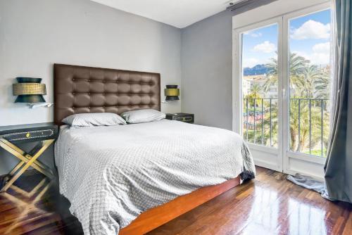 a bedroom with a bed and a large window at Altea Beach in Altea