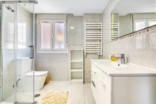 a bathroom with a shower and a sink and a toilet at Altea Beach in Altea
