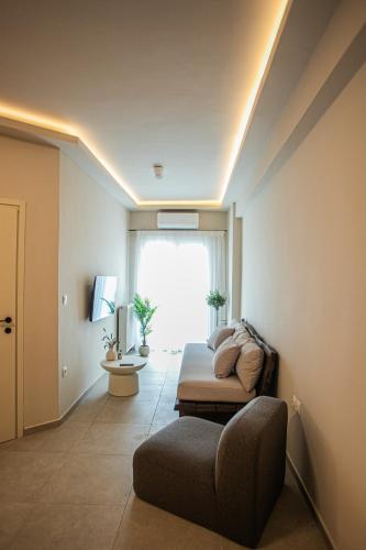 a living room with a couch and a window at Sofia's central suite in Alexandroupoli
