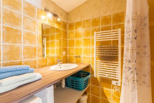 a bathroom with a sink and a mirror at La Bellimure in Saint-Christol