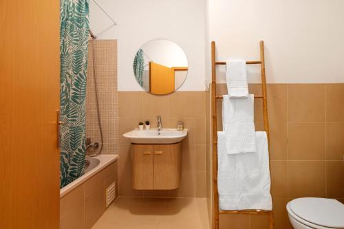 a bathroom with a sink and a toilet and a mirror at Royal Cabanas Golf 81 in Conceição