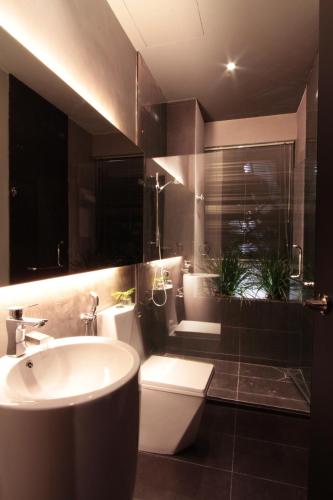 a bathroom with a white sink and a toilet at Villa Lot 1638 in Port Dickson
