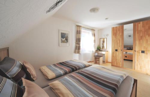 a bedroom with two beds in a room at Haus Rosenfelder Fewo Abendsonne in Bernau im Schwarzwald