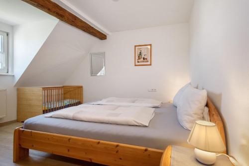 a bedroom with a bed and a crib at Haus Hilebrand in Kressbronn am Bodensee