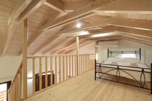 a large room with a bed in the ceiling at Maniaveta's House in Exanthia
