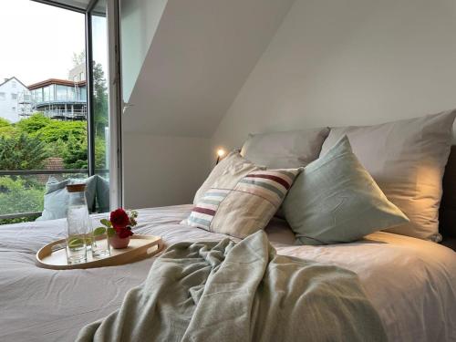 a bed with a tray with a drink on it at Meerzeit in Eckernförde