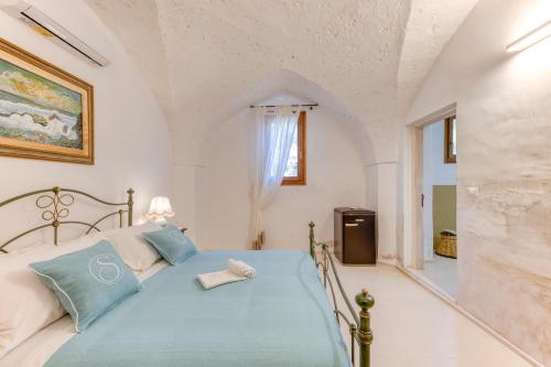 a bedroom with a bed in a room at Masseria Scafazzi - Salento in Presicce
