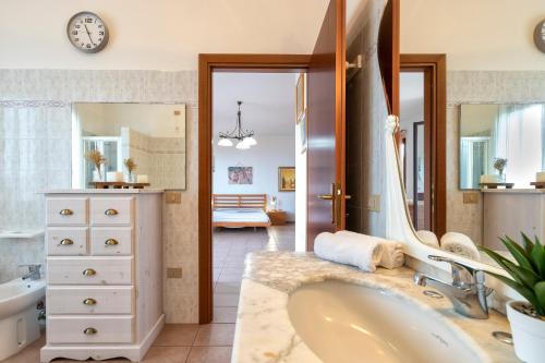 a bathroom with a tub and a sink at Villa Patrizia in Castelsardo