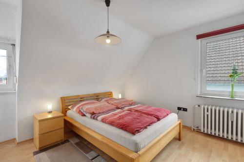 a bedroom with a bed and a window and a radiator at Ferienwohnung Ruhepol, 75qm in Vellmar