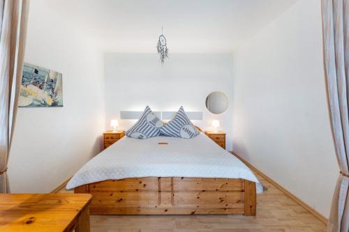 a bedroom with a wooden bed with blue pillows at Ferienwohnung 'Segelyachten-Perle' in Schilksee