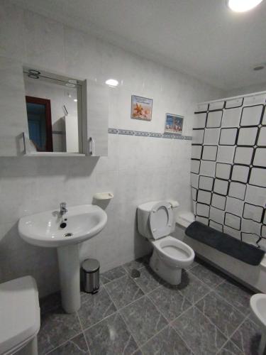 a bathroom with a toilet and a sink at O Son in Cee