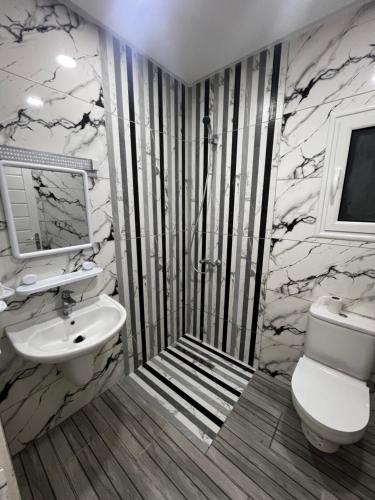 a bathroom with a sink and a toilet at Villa charme in Awlād ‘Umar