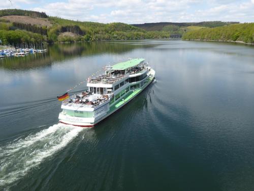 a large ferry boat on a large body of water at Ferienwohnungen Schimsheimer Rhode in Olpe