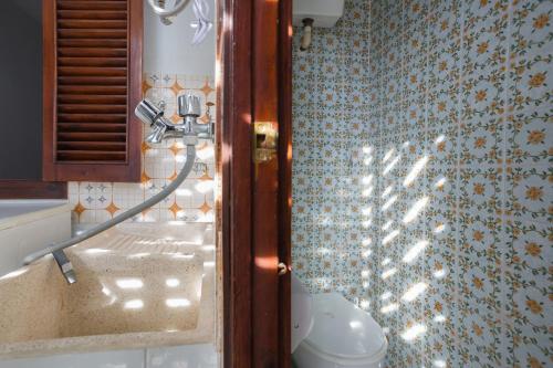 a bathroom with a shower with a toilet and a sink at Llúria 51 in Oliva
