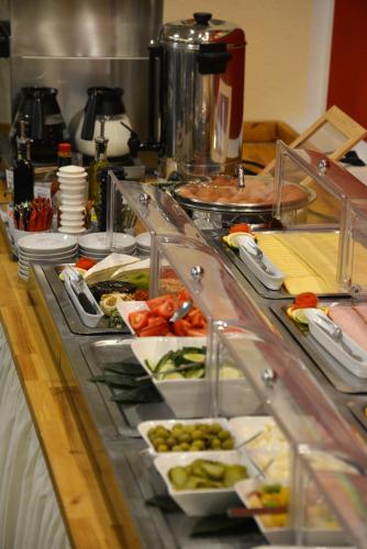 a buffet with many plates of food on a table at Hotel Italia in Munich