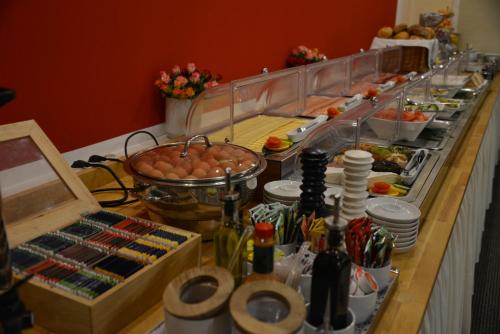 a buffet line with a lot of food and drinks at Hotel Italia in Munich