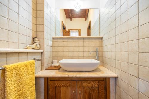 a bathroom with a white sink and a mirror at Agata House in Muravera
