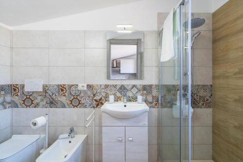 a bathroom with a sink and a mirror at Villa Sele Fontanebianche - Sud in Fontane Bianche