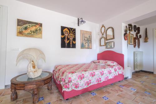 a bedroom with a red bed and a table at Casa della Poiana in Lipari