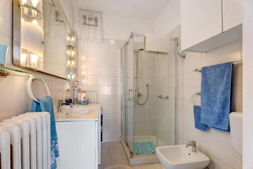 a white bathroom with a sink and a shower at Casa Lago Leo in Omegna
