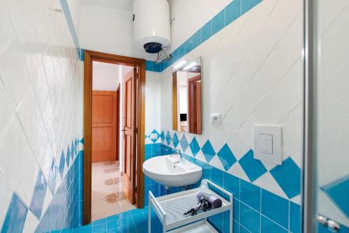 a blue and white bathroom with a sink and a mirror at Ce Tour - Casa Cetara Centro 1 in Cetara
