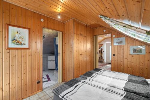 a bedroom with a bed in a wooden wall at Stoffel in Darstein