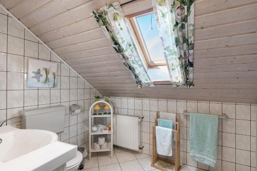 a bathroom with a sink and a toilet and a window at Stoffel in Darstein