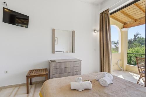 a bedroom with a bed with towels on it at Alexandra Studio 10 in Lefkimmi