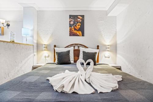 a white wedding dress on a bed in a bedroom at Unique Apartahotel 3-2 in Torrevieja