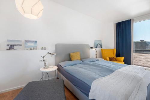 a bedroom with a bed and a table and a lamp at Hausboot Sutje in Großenbrode