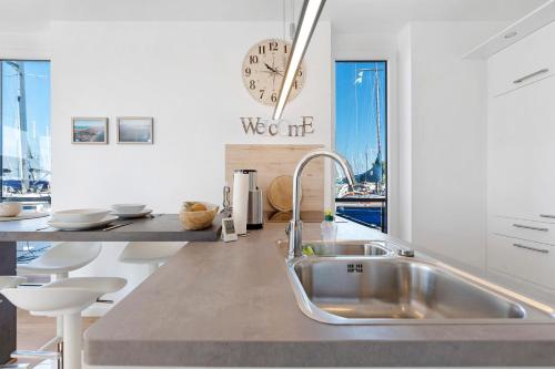 a kitchen with a sink and a counter at Hausboot Sutje in Großenbrode