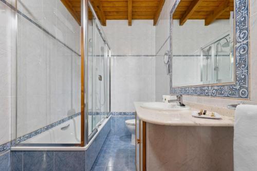 a bathroom with a sink and a shower and a toilet at Apartamentos El Rincón de Bustio in Bustio