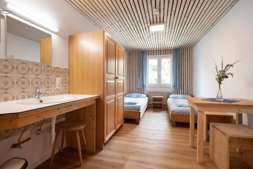 a bathroom with a sink and a bedroom at Kraichgauer Haus in Oberreute