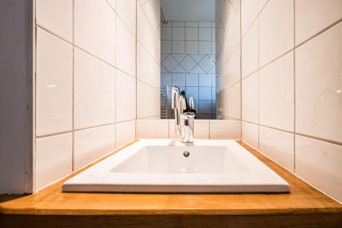 a bathroom with a white sink and a mirror at Studio 4 - La Bruyère in Crest-Voland