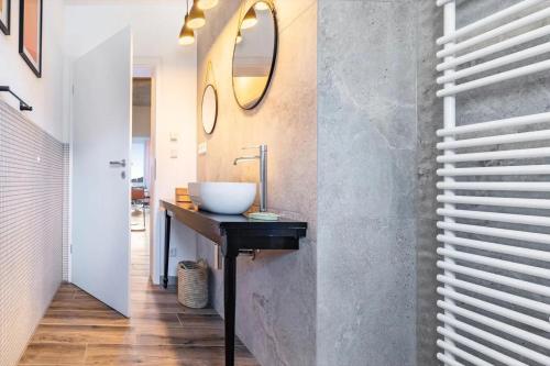 a bathroom with a sink and a mirror at Suiten im Alten Berghotel Antonia in Eslohe