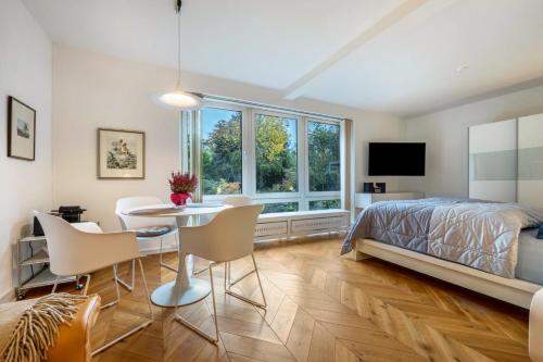 a bedroom with a bed and a table and chairs at Landhaus Bleckede - App 1 Bleckede in Bleckede